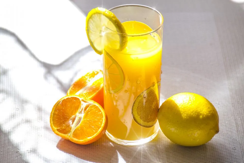 Glass of orange juice with sliced oranges and a lemon, a common fast-acting carb for treating low blood sugar